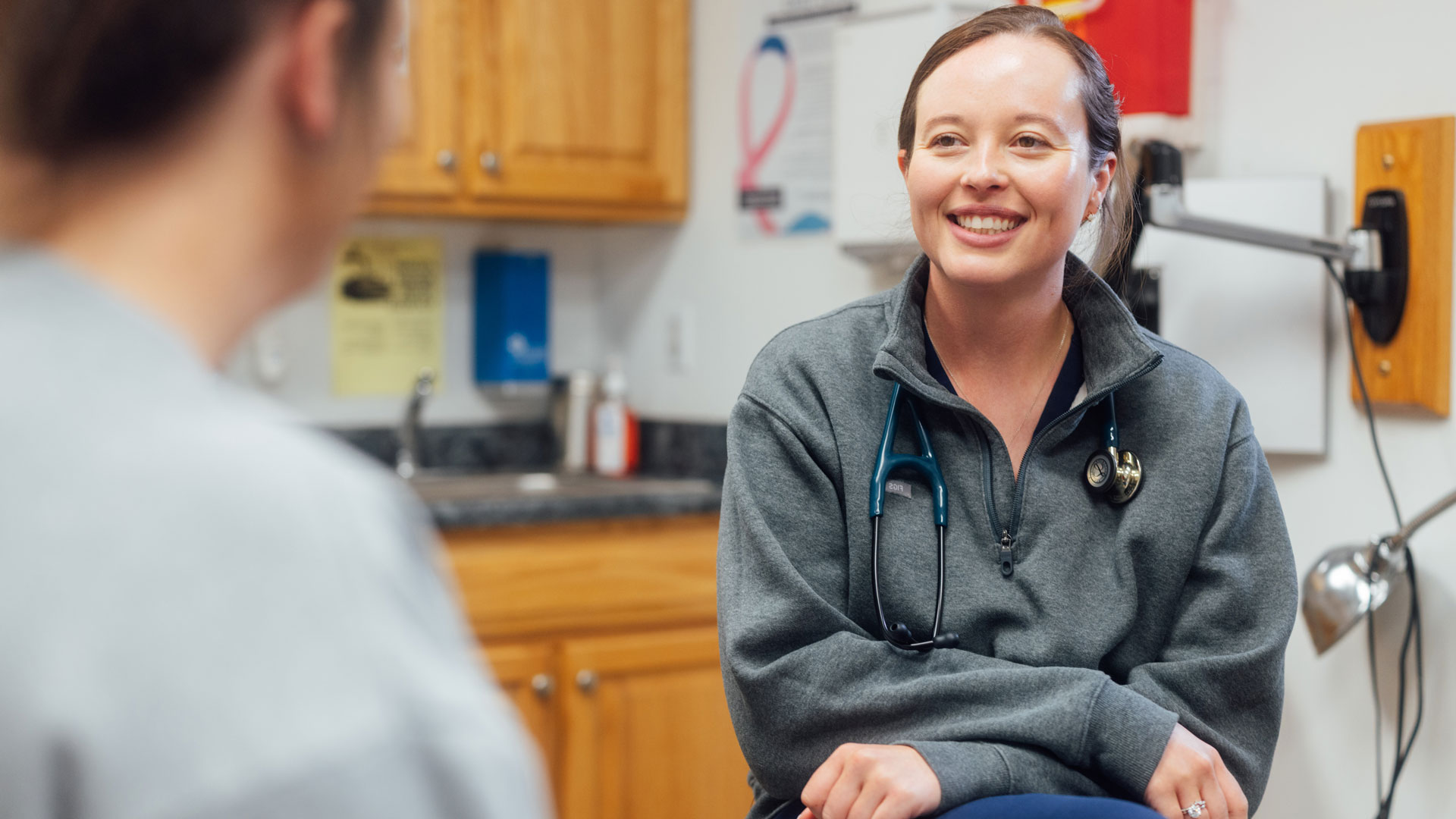 Barbour Health doctor talking to patient in patient room.