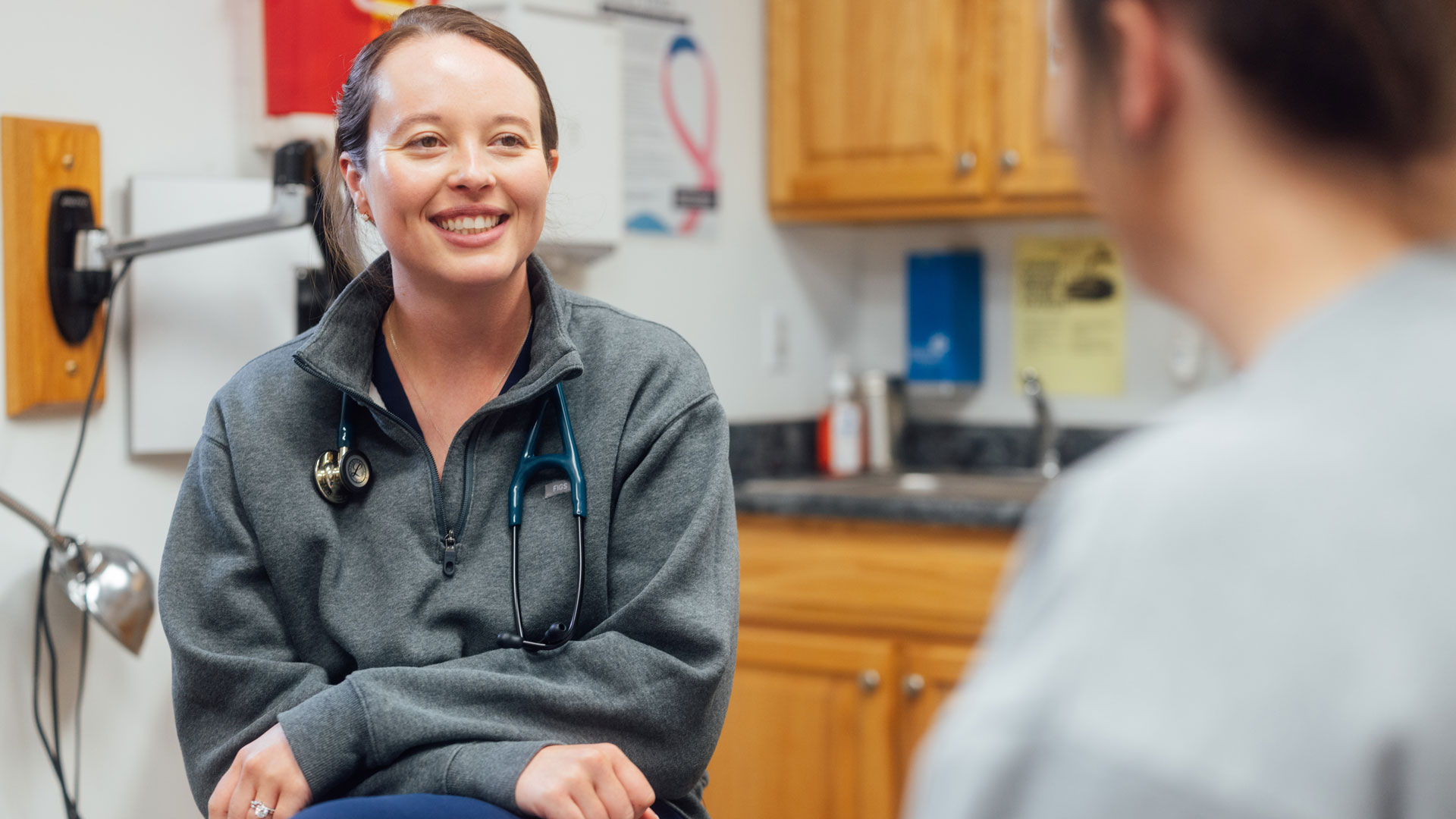 Barbour Health doctor talking to patient in patient room.
