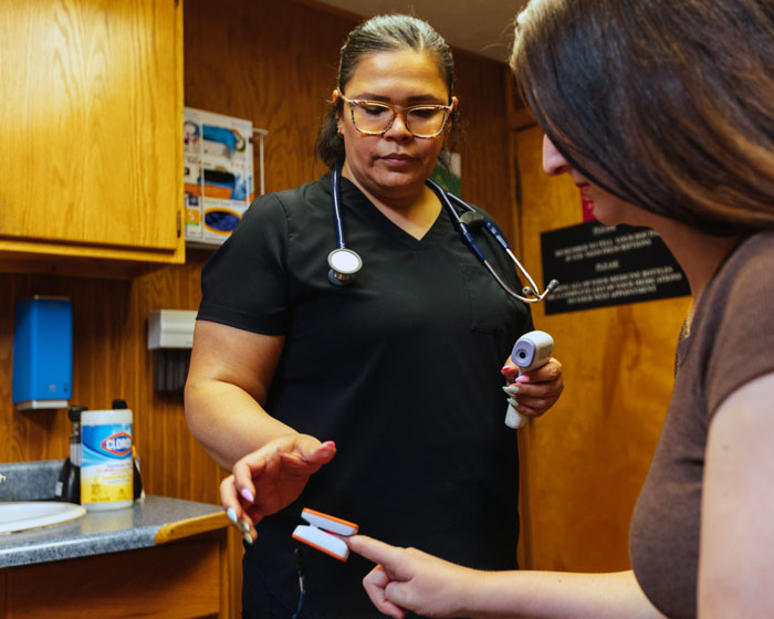 Doctor performing routine checkup on female patient.