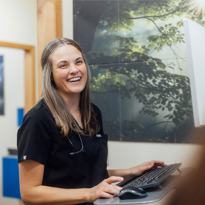 Doctor at Barbour Health taking a patients information on a computer.