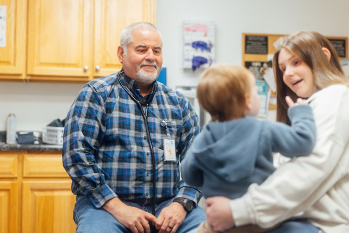 Pediatric doctor in patients room with mother and child.
